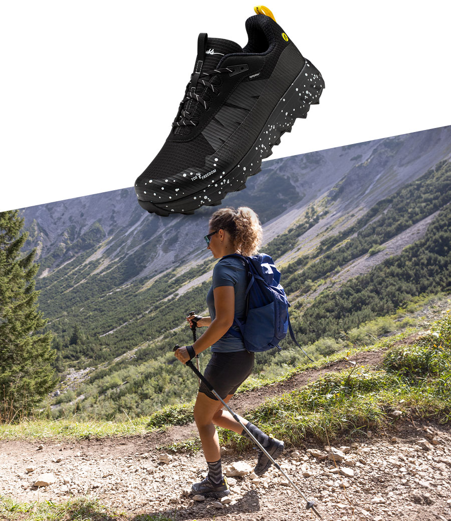 Closeup des Joe Nimble Explore Addict Trailschuh in schwarz mit Läufer in den Bergen